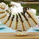 An elaborate cornucopia made of pastry, precariously balanced on a smaller pastry
